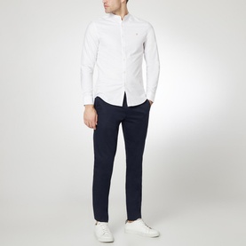 Model wearing Farah Vintage Brewer Grandad Shirt in white, styled with navy trousers and white trainers