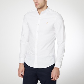 Model wearing Farah Vintage Brewer Grandad Shirt in white, styled with navy trousers
