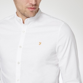 Model wearing Farah Vintage Brewer Grandad Shirt in white, featuring a grandad collar and embroidered logo chest badge