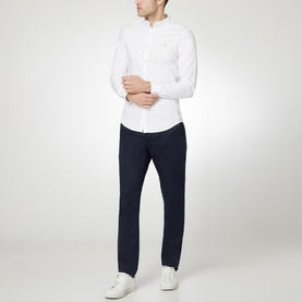 Model wearing Farah Vintage Brewer Grandad Shirt in white, styled with navy trousers and white trainers