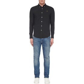 Model wearing Farah Vintage Brewer Slim Fit Shirt in black, styled with blue washed slim-fit jeans and white trainers