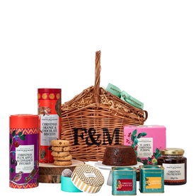 Fortnum & Mason The Very Merry Hamper, wicker basket with F&M monogram, filled with festive biscuits, pudding, teas, and preserves