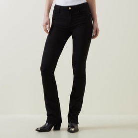 Model wearing FRAME DENIM Le Mini Boot High-Rise Jeans in black bootcut style with gold-tone button detail, styled with black heeled ankle boots