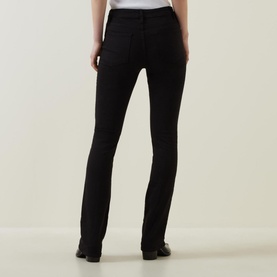 Model wearing FRAME DENIM Le Mini Boot High-Rise Jeans in black, rear view, slim bootcut fit, styled with black flat shoes