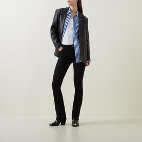 Model wearing FRAME DENIM Le Mini Boot High-Rise Jeans in black bootcut fit, styled with a blue stripe shirt and dark leather blazer