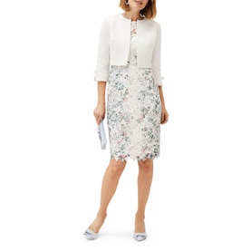 Model wearing Phase Eight Franky Lace Dress in cream with floral lace skirt, styled with a white cropped jacket and silver heels