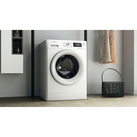 Whirlpool FreshCare 8kg 1400 Spin 6th Sense Clean white washing machine in a laundry room setting with basket and towel