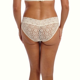 Model wearing Wacoal Halo Lace Briefs in cream, shown from behind, featuring allover floral lace and scalloped waistband