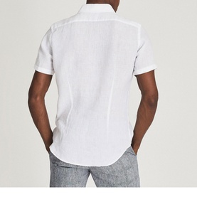 Model wearing Reiss Holiday Linen Slim Fit Shirt in white, short sleeves, rear view, styled with grey linen trousers