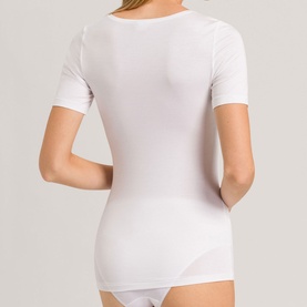 Model wearing Hanro Soft Touch Short Sleeve Top in white, shown from behind, paired with white briefs