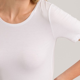 Model wearing Hanro Soft Touch Short Sleeve Top in white, close-up showing scoop neckline and fitted silhouette