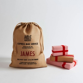 Harrow & Green brown hessian personalised Santa sack with drawstring, printed with "James" Express Mail Service, shown with wrapped gifts