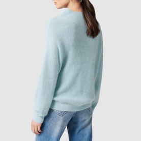 Model wearing Forever New Hester Rib Knit Sweater in blue, relaxed fit with stand neck and deep cuffs, styled with light wash jeans