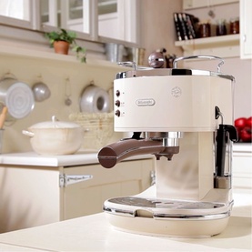DeLonghi Icona Vintage Traditional Pump Espresso Machine in cream, with chrome detailing and wood-effect handle, styled in a kitchen setting