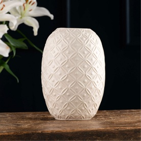 Belleek Inish 10" Vase in white ceramic with embossed diamond lattice texture, styled with white lily flowers on wooden surface