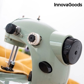InnovaGoods Mini Portable Sewing Machine in mint green, close-up showing thread tension dial and bobbin controls with yellow fabric