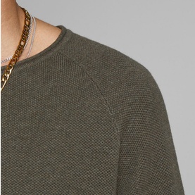 Model wearing Jack & Jones Textured Crew Sweater in khaki, close-up of ribbed knit texture and crew neckline, styled with gold chain necklace