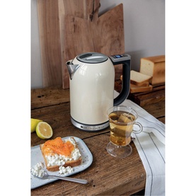 KitchenAid 1.7L Cream Kettle with digital temperature display, styled on a wooden table with tea, bread and lemon