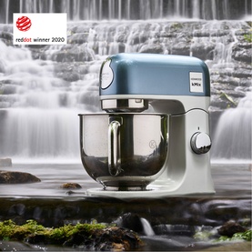 Kenwood Stand Mixer With 5 Litre Bowl in blue, stainless steel bowl, shown outdoors near waterfall. Red Dot Winner 2020.