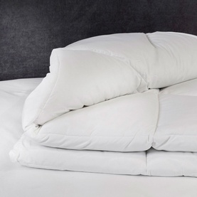 Karla Bree Microfill Supersoft 13.5 Tog Duvet in white, shown folded on a bed displaying its plump, quilted fill