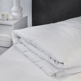 Karla Bree Microfill Supersoft All Seasons Duvet in white, folded back on a made bed with crisp white bedding