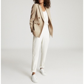 Model wearing Reiss Larsson Double Breasted Blazer in beige, styled with white camisole, white trousers and white trainers
