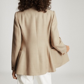 Model wearing Reiss Larsson Double Breasted Blazer in beige, rear view, styled with white trousers