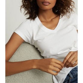 Model wearing Reiss Luana V-Neck T-Shirt in white, styled with light blue jeans, cropped view showing neckline detail