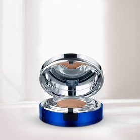 La Prairie Skin Caviar Essence-in-Foundation SPF25 in Satin Nude, open compact showing cushion pan with integrated mirror, blue chrome case