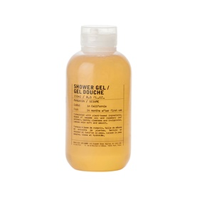 Le Labo Mandarin Shower Gel, amber-toned liquid in clear bottle with label detailing scent and usage instructions