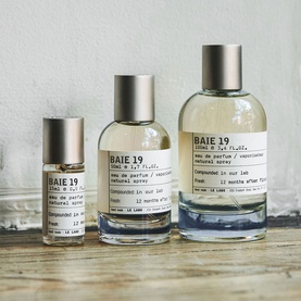 Le Labo BAIE 19 Eau de Parfum in three sizes: roll-on, 50ml and 100ml bottles with silver caps on a wooden surface