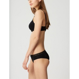 Model wearing Lejaby La Petite Brief in black, styled with matching black bra, side profile view showing lace trim detail