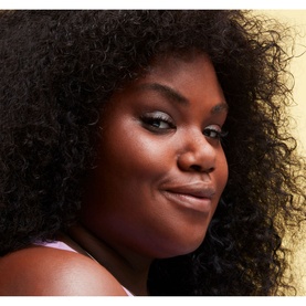 Model with MAC Studio Radiance Face And Body Radiant Sheer Foundation, showing glowing, sheer complexion finish with subtle shimmer eye look