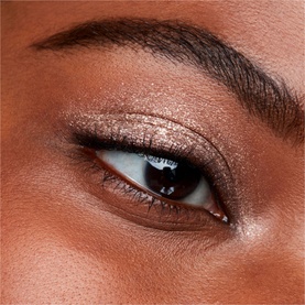 Close-up eye look wearing MAC Dazzleshadow Liquid in Every Day Is Sunshine, a shimmering rose-gold metallic eyeshadow