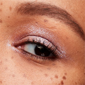 MAC Dazzleshadow Liquid eye shadow in Diamond Crumbles applied to eyelid, showing shimmery lilac-pink metallic finish