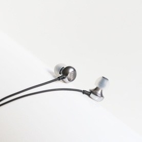 RHA MA650i Lightning Headphones with Microphone in gunmetal grey, wired in-ear design with aluminium housings on white surface