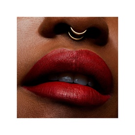 Model with MAC Retro Matte Liquid Lipcolour in Feels So Grand, a deep red matte finish shown on lips, with gold septum ring visible