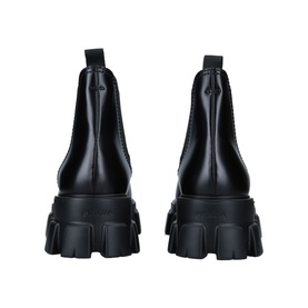 Prada Monolith XL Chelsea Boots in black leather, rear view showing elastic gussets and chunky lug sole
