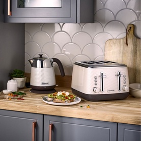 Kenwood Mesmerine 4 Slice Toaster in cream and brown, styled with matching kettle on wooden kitchen counter