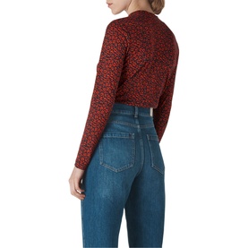Model wearing Whistles Ikat Print Essential Top in red floral print, back view, styled with blue high-waisted jeans