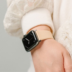Model with Nomad Modern Slim Strap 40mm/38mm in nude beige leather on Apple Watch, silver case, styled with cream lace top