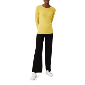 Model wearing Phase Eight Molla Crew Neck Sweater in yellow, styled with wide-leg black trousers and white trainers