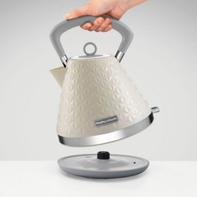 Morphy Richards Vector Trad Kettle Cream 1.5L being lifted from base, embossed floral texture, silver accents and grey handle