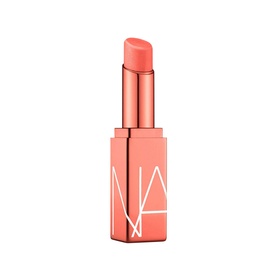 NARS Afterglow Lip Balm in Torrid, coral-pink bullet in rose gold square case with embossed NА logo