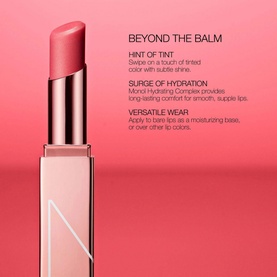 NARS Afterglow Lip Balm in Torrid, a sheer pink shade, shown upright against a coral-pink background with product benefit text