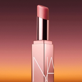 NARS Afterglow Lip Balm in Torrid, sheer pink-nude bullet in rose gold rectangular case, cap removed