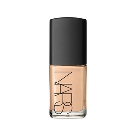 NARS Sheer Glow Foundation in a glass bottle with black cap, light beige shade, pump-free formula