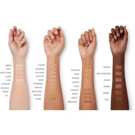 NARS Sheer Glow Foundation shade range swatched across four arms showing light to deep skin tones with named shades