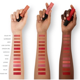 NARS Air Matte Lip Colour swatches across three skin tones, showing 12 shades including Thrust, in nude to deep red tones