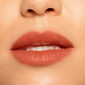 Model wearing NARS Air Matte Lip Colour in Morocco, a warm terracotta nude matte finish, shown close up on lips
